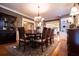 Elegant dining room with hardwood floors, a decorative rug, and a large wooden table with seating for eight at 1187 Plantation Dr, Villa Rica, GA 30180