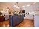 Bright kitchen with white cabinets, stainless steel appliances, and a center island, flowing into the living area at 1187 Plantation Dr, Villa Rica, GA 30180
