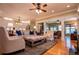 Spacious living room featuring hardwood floors, a ceiling fan, neutral tones, and seamless access to the kitchen at 1187 Plantation Dr, Villa Rica, GA 30180