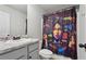 Stylish bathroom features vanity sink with granite countertop and unique artistic shower curtain at 1901 Creel Ln, Atlanta, GA 30349