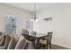 Dining area with a wooden table, comfortable seating, and modern lighting fixture at 1901 Creel Ln, Atlanta, GA 30349