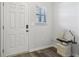 Bright foyer with a white front door, modern digital lock, and wood-look flooring at 1901 Creel Ln, Atlanta, GA 30349