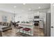 Open-concept kitchen and dining area featuring stainless steel appliances, granite countertops, and hardwood floors at 1901 Creel Ln, Atlanta, GA 30349