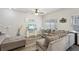 Comfortable living room featuring a gray sectional, ottoman, stylish decor, and wood-look floors at 1901 Creel Ln, Atlanta, GA 30349
