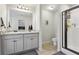Main bathroom featuring double sinks, a shower, and ample counter space with vanity storage space at 1901 Creel Ln, Atlanta, GA 30349