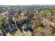 An aerial view of an estate surrounded by lush greenery and mature trees in a suburban setting at 2461 Oak Grove Ne Ests, Atlanta, GA 30345