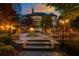 Elegant outdoor living space with a fire pit, pavilion, and beautifully landscaped yard at 2461 Oak Grove Ne Ests, Atlanta, GA 30345