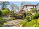 Expansive backyard with lush landscaping, meandering stone pathways, and manicured shrubs at 2461 Oak Grove Ne Ests, Atlanta, GA 30345