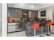 Stylish home bar area features gray cabinetry, a wine fridge, and custom lighting at 2461 Oak Grove Ne Ests, Atlanta, GA 30345