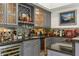 Beautiful wet bar with custom cabinets, bar seating, and a wine refrigerator at 2461 Oak Grove Ne Ests, Atlanta, GA 30345