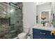 Contemporary bathroom featuring a glass shower with stylish fixtures, a vanity, and modern finishes at 2461 Oak Grove Ne Ests, Atlanta, GA 30345