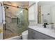 Elegant bathroom featuring a walk-in shower with glass door, sleek fixtures, and a modern vanity with ample lighting at 2461 Oak Grove Ne Ests, Atlanta, GA 30345