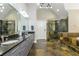 Large bathroom with tiled floor, a shower with glass door, and double sinks at 2461 Oak Grove Ne Ests, Atlanta, GA 30345