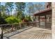 An expansive wooden deck overlooks beautifully landscaped backyard, with a screened-in porch perfect for outdoor relaxation at 2461 Oak Grove Ne Ests, Atlanta, GA 30345