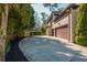 Long driveway with mature trees leading to the two-car garage and a brick house at 2461 Oak Grove Ne Ests, Atlanta, GA 30345