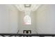 Stunning foyer with a large arched window above the entryway, and modern light fixture at 2461 Oak Grove Ne Ests, Atlanta, GA 30345