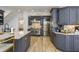 A gourmet kitchen features stainless steel appliances, gray cabinetry, and a marble-topped island at 2461 Oak Grove Ne Ests, Atlanta, GA 30345