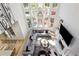 Bright living room boasts floor-to-ceiling windows, stylish lighting fixture, fireplace, and comfortable, modern furniture at 2461 Oak Grove Ne Ests, Atlanta, GA 30345