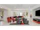 Modern living room with a large red sofa, bay windows, and a unique lighting fixture at 2461 Oak Grove Ne Ests, Atlanta, GA 30345