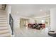 Open-concept living room featuring a red leather sofa, marble floors, and many windows at 2461 Oak Grove Ne Ests, Atlanta, GA 30345
