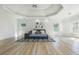 Expansive main bedroom with tray ceilings, light wood floors, and many windows for natural light at 2461 Oak Grove Ne Ests, Atlanta, GA 30345