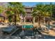 Luxury home with a beautiful pool featuring rock features, a spa and palm trees at 2461 Oak Grove Ne Ests, Atlanta, GA 30345
