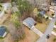 Aerial view of a home featuring a driveway, mature trees, well-maintained landscaping, and an asphalt roof at 57 Sorghum Ct, Dallas, GA 30157