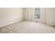 Bedroom with neutral walls and carpet, bright arched window, and ample space at 57 Sorghum Ct, Dallas, GA 30157
