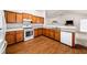 This kitchen showcases beautiful wood cabinets, modern appliances, and seamless access to the living area at 57 Sorghum Ct, Dallas, GA 30157