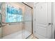 Updated shower with glass door and grab bars, featuring attractive tile work and a shower curtain at 57 Sorghum Ct, Dallas, GA 30157