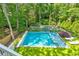 Aerial view showcasing a sparkling pool, spa, and tennis court, surrounded by lush greenery and manicured lawns at 891 Glenbrook Nw Dr, Atlanta, GA 30318