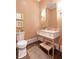 Elegant powder room with a marble countertop vanity, stylish mirror, and decorative wallpaper at 891 Glenbrook Nw Dr, Atlanta, GA 30318