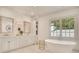 Bright bathroom with a soaking tub, double vanity, and a large window overlooking the outdoors at 891 Glenbrook Nw Dr, Atlanta, GA 30318