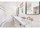 Modern bathroom with white subway tile, marble countertops, and black and white patterned floors at 891 Glenbrook Nw Dr, Atlanta, GA 30318