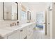 Stylish bathroom featuring double sinks, marble countertops, and black and white patterned floors at 891 Glenbrook Nw Dr, Atlanta, GA 30318