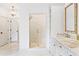 Elegant bathroom with a glass shower, marble countertops, white cabinets, and herringbone tile floors at 891 Glenbrook Nw Dr, Atlanta, GA 30318