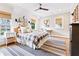 Charming bedroom featuring shiplap walls, a ceiling fan, and natural light at 891 Glenbrook Nw Dr, Atlanta, GA 30318