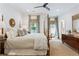 Spacious bedroom with a four-poster bed, sitting area, and hardwood floors at 891 Glenbrook Nw Dr, Atlanta, GA 30318