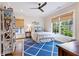 Comfortable bedroom with a queen bed, ceiling fan, and large windows at 891 Glenbrook Nw Dr, Atlanta, GA 30318