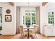 Cozy breakfast nook with a round table, elegant chairs, and a large window offering a garden view at 891 Glenbrook Nw Dr, Atlanta, GA 30318