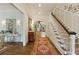 Elegant entryway featuring hardwood floors, staircase, and an arched doorway leading to the dining room at 891 Glenbrook Nw Dr, Atlanta, GA 30318