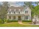 Charming two-story home with a covered front porch, landscaped yard, and a welcoming entrance at 891 Glenbrook Nw Dr, Atlanta, GA 30318