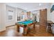 Spacious game room with a pool table, wood floors, and rustic sliding barn doors to the workout room at 891 Glenbrook Nw Dr, Atlanta, GA 30318