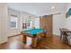 Game room with a pool table, hardwood floors, and a sliding barn door, perfect for entertaining at 891 Glenbrook Nw Dr, Atlanta, GA 30318