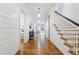 Bright hallway features hardwood floors, shiplap walls, staircase, sliding barn door and view of the entry and bedroom at 891 Glenbrook Nw Dr, Atlanta, GA 30318
