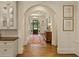 Arched hallway showcasing hardwood floors, a decorative runner, and access to the front entrance at 891 Glenbrook Nw Dr, Atlanta, GA 30318