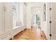 Bright hallway with hardwood floors, custom built-ins, and an inviting view into the adjoining living area at 891 Glenbrook Nw Dr, Atlanta, GA 30318