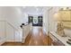 Hallway with hardwood floors, crown molding, and built-in bookcases at the end of the hall at 891 Glenbrook Nw Dr, Atlanta, GA 30318