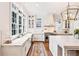 Bright, elegant kitchen with marble countertops, farmhouse sink, stainless appliances, and an oversized island at 891 Glenbrook Nw Dr, Atlanta, GA 30318