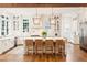 Stylish kitchen boasts custom white cabinetry, stainless steel appliances, and a central island with barstool seating at 891 Glenbrook Nw Dr, Atlanta, GA 30318